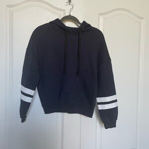 Dark blue hoodie with white stripes on sleeve.